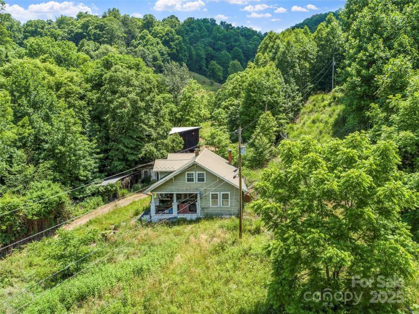 263 Wolf Mountain Road, Green Mountain, NC 28740.  MLS# CAR4148202, YatesRealty ID 3574. Older farmhouse on lower portion of property