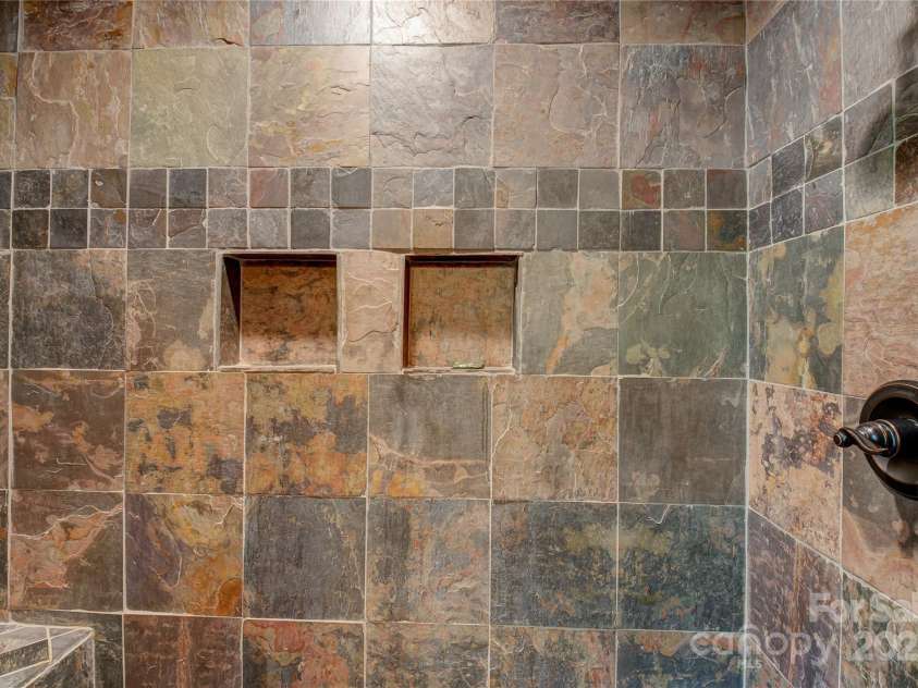 200 Blue Gill Drive, Lake Lure, NC 28746.  MLS# CAR4231611, YatesRealty ID 3580. Primary bath has a lovely tiled shower