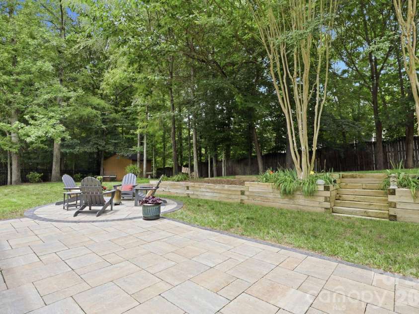 7011 Edenderry Drive, Charlotte, NC 28270.  MLS# CAR4397470, YatesRealty ID 35827. Expansive paver patio with fire pit area