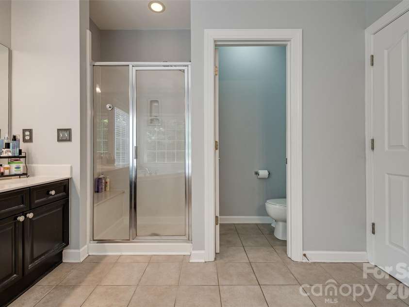 14427 Maclauren Lane, Huntersville, NC 28078.  MLS# CAR4400774, YatesRealty ID 35836. Walk-in shower and water closet in Primary bathroom