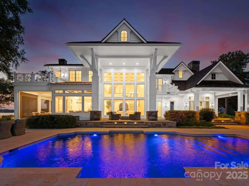 124 Wellcraft Court, Mooresville, NC 28117.  MLS# CAR4227104, YatesRealty ID 3586. At sunset, the heated pool glows warmly, beautifully lit and inviting in the fading light.