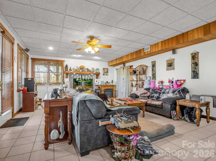 261 Boland Drive, Lake Lure, NC 28746.  MLS# CAR4232429, YatesRealty ID 3592. Finished Basement Living Room