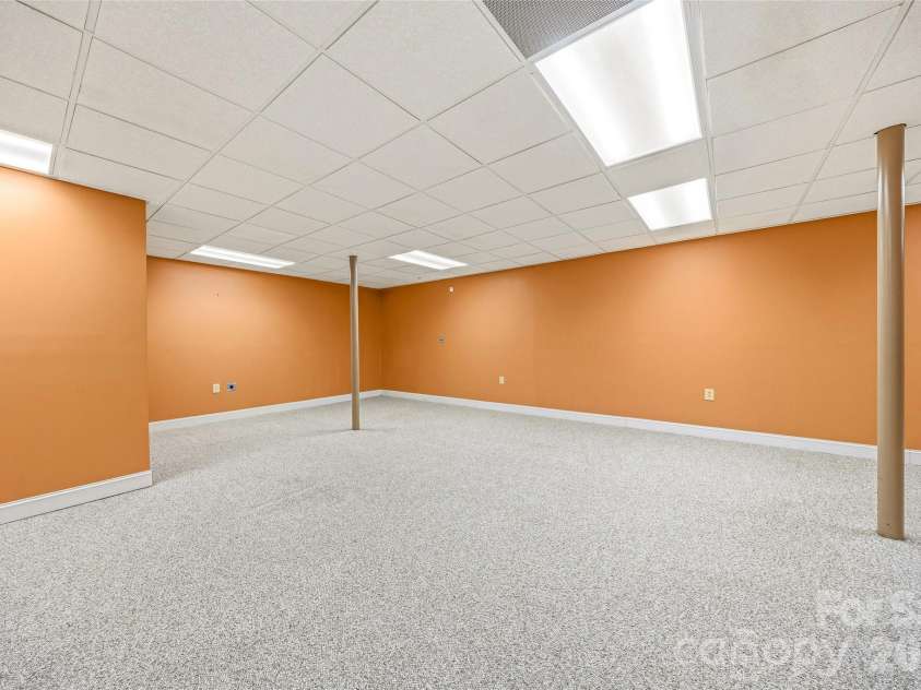 200 Teaberry Lane, Hendersonville, NC 28739.  MLS# CAR4399670, YatesRealty ID 36016. Additional Lower-Level Flex Space
