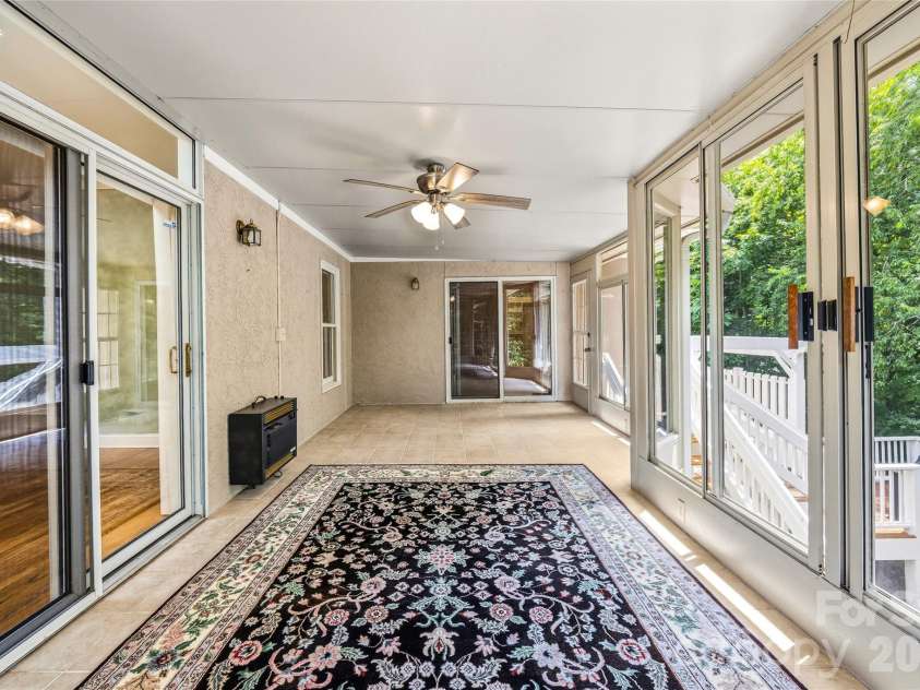 200 Teaberry Lane, Hendersonville, NC 28739.  MLS# CAR4399670, YatesRealty ID 36016. Sunroom overlooking the backyard.
