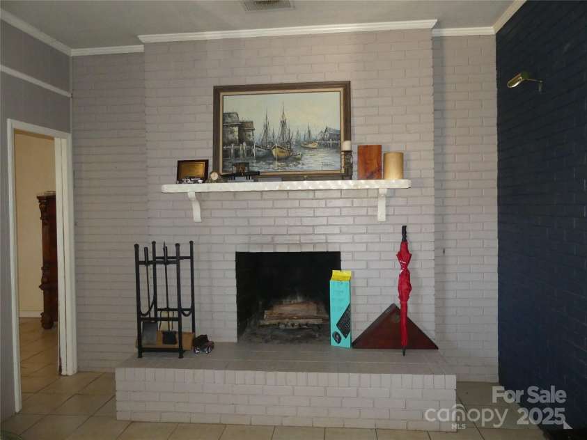 355 Swink Avenue, Salisbury, NC 28147.  MLS# CAR4314538, YatesRealty ID 3602. Wood burning fireplace in the den.