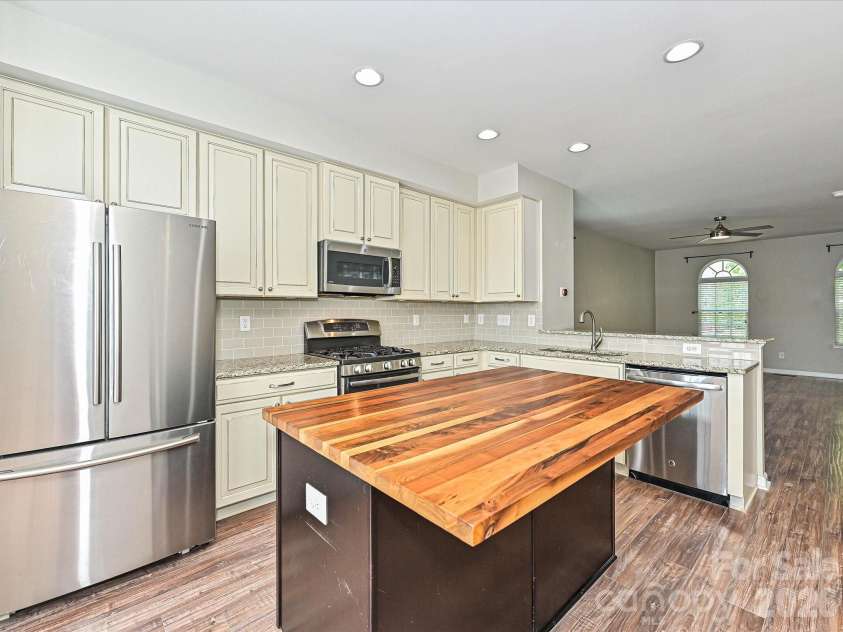 19791 Playwrights Way, Cornelius, NC 28031.  MLS# CAR4388972, YatesRealty ID 36024. Kitchen with Butcher Block Island