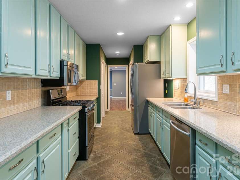31 Timber Park Drive, Black Mountain, NC 28711.  MLS# CAR4336754, YatesRealty ID 3605. Kitchen view looking towards the dining area (barn doors)