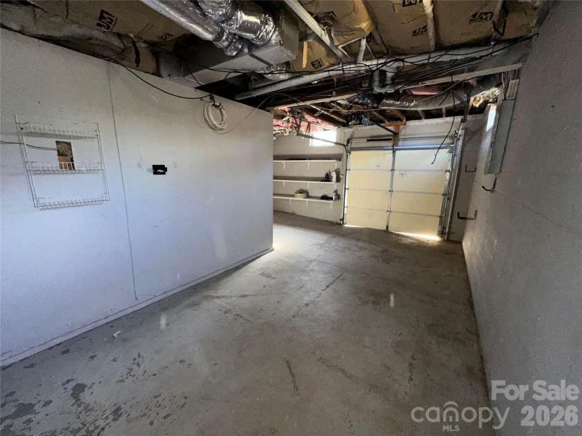 413 Roberts Street, Salisbury, NC 28144.  MLS# CAR4341075, YatesRealty ID 3605. Deep 1-car garage view from back wall to door 