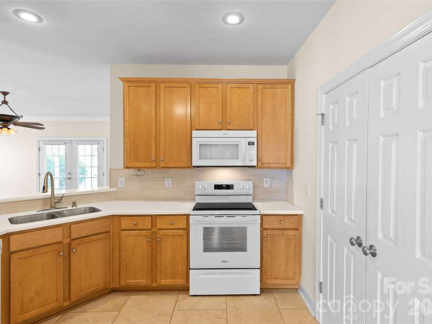 1017 Curry Way, Matthews, NC 28104.  MLS# CAR4402195, YatesRealty ID 36064. Solid surface counters and tile backsplash in kitchen