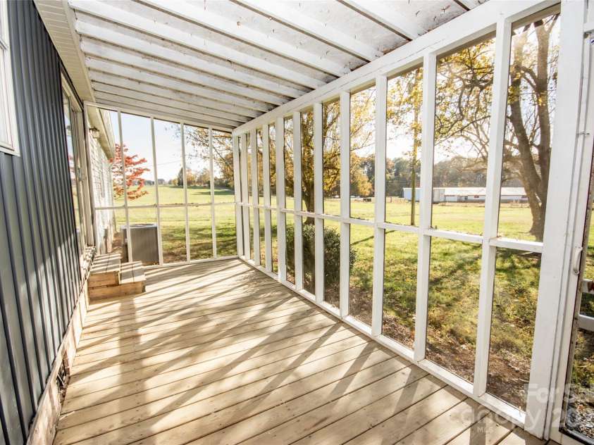 943 Tabor Road, Olin, NC 28660.  MLS# CAR4319811, YatesRealty ID 3609. Back porch, enjoy this outdoor space all year long!