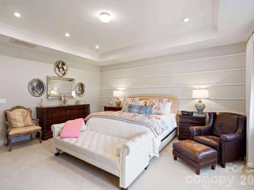4135 Merkland Lane, Charlotte, NC 28226.  MLS# CAR4401079, YatesRealty ID 36090. Generous primary bedroom retreat with tray ceiling and private sitting area — a serene owner's suite minutes from SouthPark & Ballantyne.