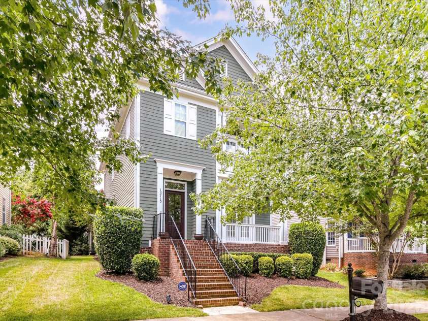 15715 Taviston Street, Huntersville, NC 28078.  MLS# CAR4401975, YatesRealty ID 36105. Classic Southern charm shines from this beautifully landscaped Monteith Park home, where dual covered front porches create an inviting first impression in one of Huntersville's most sought-after communities.