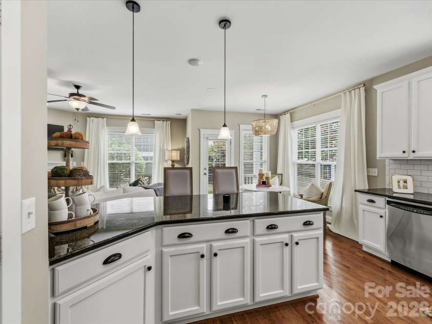 15715 Taviston Street, Huntersville, NC 28078.  MLS# CAR4401975, YatesRealty ID 36105. Designed with both style and function in mind, the kitchen offers sleek granite countertops, stainless steel appliances, ample cabinet storage, tile back splash, pantry and an island with seating.