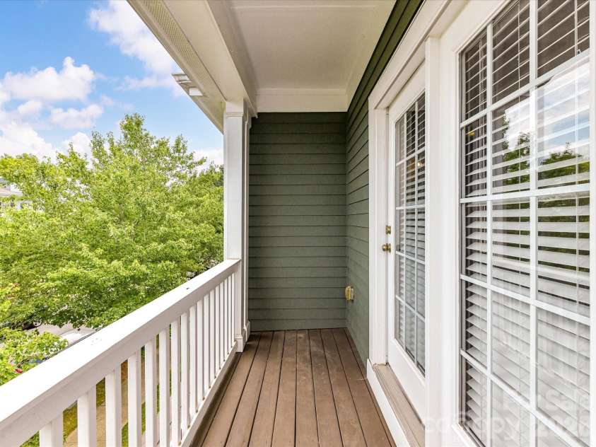 15715 Taviston Street, Huntersville, NC 28078.  MLS# CAR4401975, YatesRealty ID 36105. Enjoy your morning coffee or evening unwind from the private covered balcony overlooking the tree-lined streets and charming surroundings of Monteith Park.