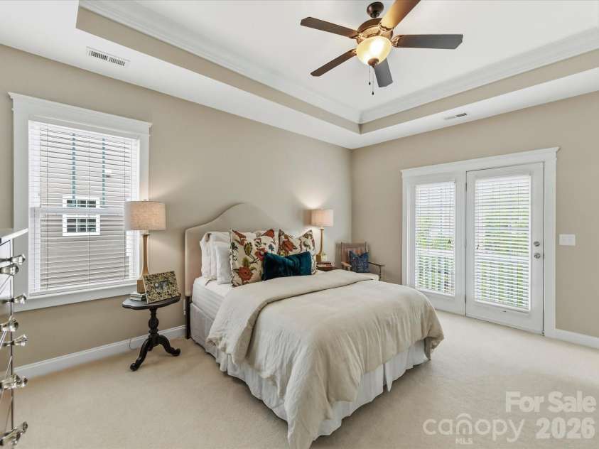 15715 Taviston Street, Huntersville, NC 28078.  MLS# CAR4401975, YatesRealty ID 36105. Retreat to the spacious primary suite on the upper level featuring an elegant tray ceiling, abundant natural light, and private access to a covered balcony.