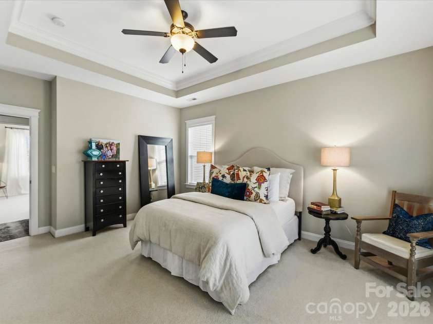 15715 Taviston Street, Huntersville, NC 28078.  MLS# CAR4401975, YatesRealty ID 36105. Retreat to the spacious primary suite on the upper level featuring an elegant tray ceiling, abundant natural light, and private access to a covered balcony.