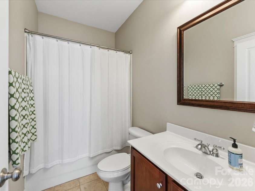 15715 Taviston Street, Huntersville, NC 28078.  MLS# CAR4401975, YatesRealty ID 36105. The full guest bathroom features a spacious vanity, tub/shower combination, and timeless finishes designed for everyday convenience.