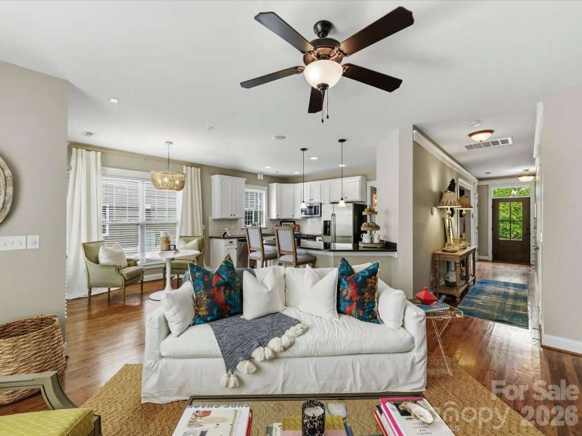15715 Taviston Street, Huntersville, NC 28078.  MLS# CAR4401975, YatesRealty ID 36105. The spacious family room features rich hardwood floors, a cozy fireplace, and an open-concept layout that flows seamlessly into the kitchen and breakfast area—perfect for everyday living and entertaining.