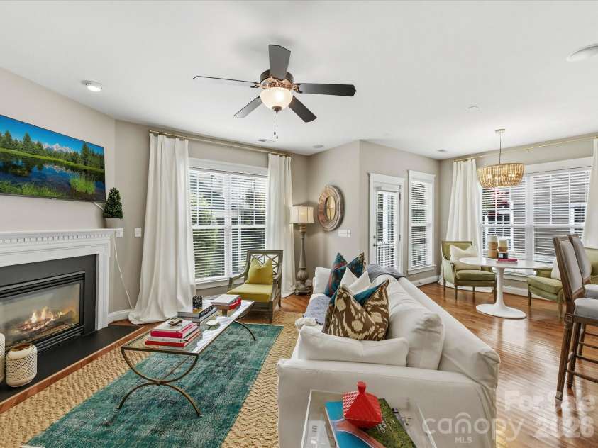15715 Taviston Street, Huntersville, NC 28078.  MLS# CAR4401975, YatesRealty ID 36105. The spacious great room features rich hardwood floors, a cozy fireplace, and an open-concept layout that flows seamlessly into the kitchen and breakfast area—perfect for everyday living and entertaining.