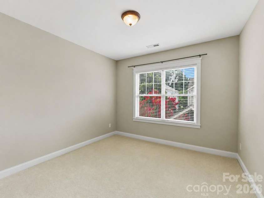 15715 Taviston Street, Huntersville, NC 28078.  MLS# CAR4401975, YatesRealty ID 36105. The spacious secondary bedroom offers abundant natural light and flexible space for family, guests, or a home office.