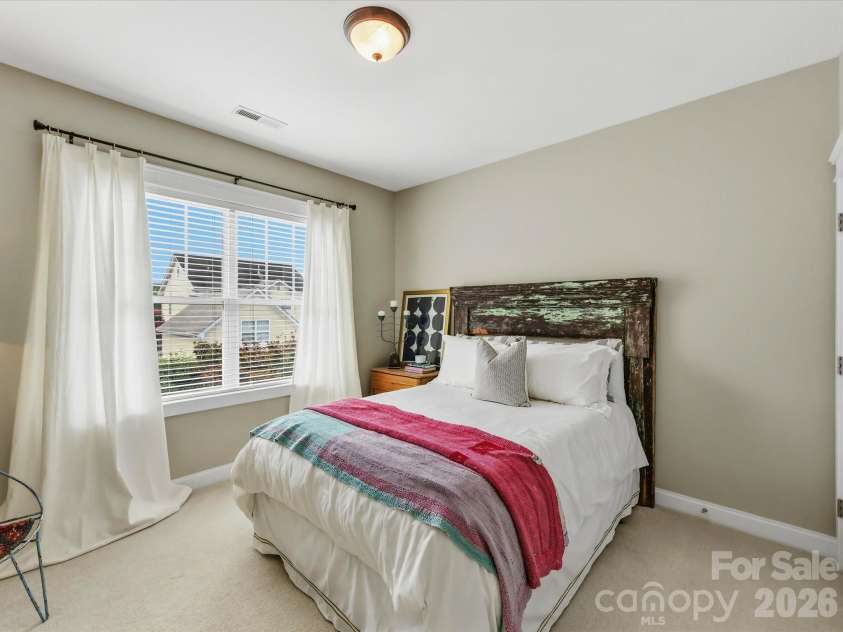 15715 Taviston Street, Huntersville, NC 28078.  MLS# CAR4401975, YatesRealty ID 36105. The spacious secondary bedroom offers abundant natural light and flexible space for family, guests, or a home office.