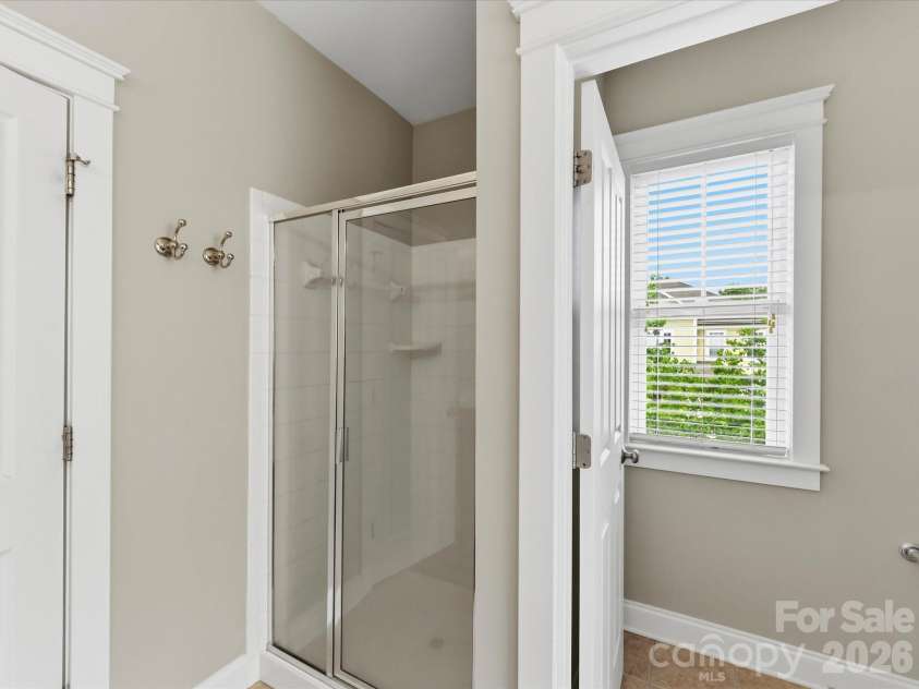 15715 Taviston Street, Huntersville, NC 28078.  MLS# CAR4401975, YatesRealty ID 36105. The well-designed primary bath showcases dual vanities, a relaxing garden tub, a separate shower and a spacious layout that enhances the owner's retreat.