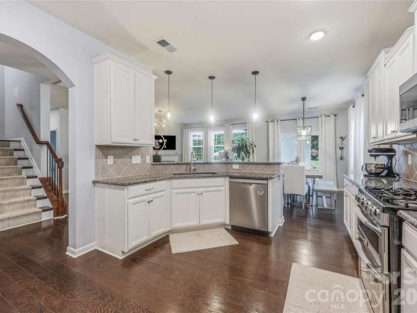 14336 Baytown Court, Huntersville, NC 28078.  MLS# CAR4399744, YatesRealty ID 36107. Another view highlights the generous workspace and open layout connecting the kitchen to the main living areas.