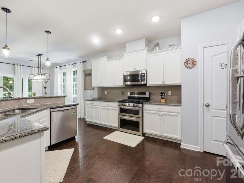 14336 Baytown Court, Huntersville, NC 28078.  MLS# CAR4399744, YatesRealty ID 36107. Bright white kitchen features granite countertops, stainless appliances, and abundant cabinetry.