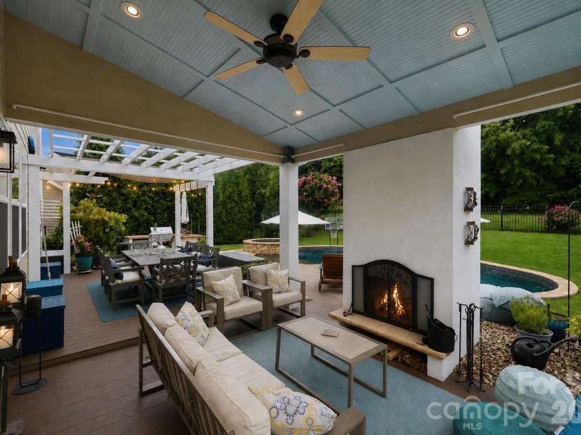 14336 Baytown Court, Huntersville, NC 28078.  MLS# CAR4399744, YatesRealty ID 36107. Cozy covered porch with fireplace extends your living space outdoors year-round.