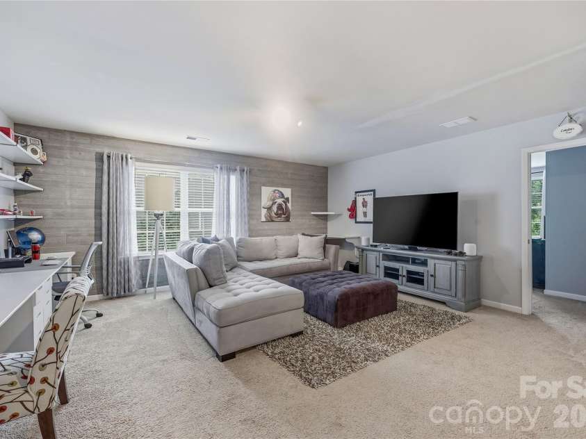 14336 Baytown Court, Huntersville, NC 28078.  MLS# CAR4399744, YatesRealty ID 36107. Expansive second-floor loft area beautifully accented with a wood-paneled wall.