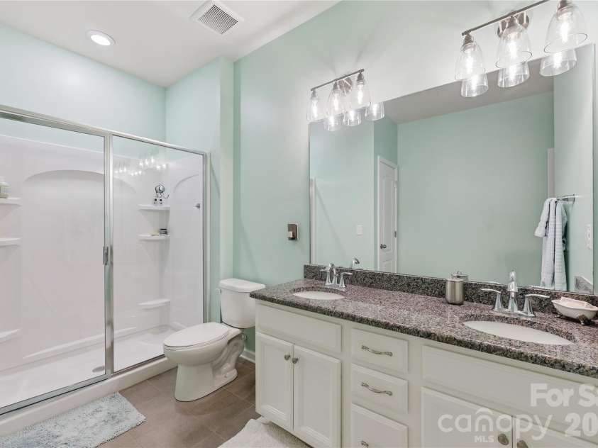 14336 Baytown Court, Huntersville, NC 28078.  MLS# CAR4399744, YatesRealty ID 36107. Luxurious guest bath features dual vanities, soaking tub, and oversized shower.