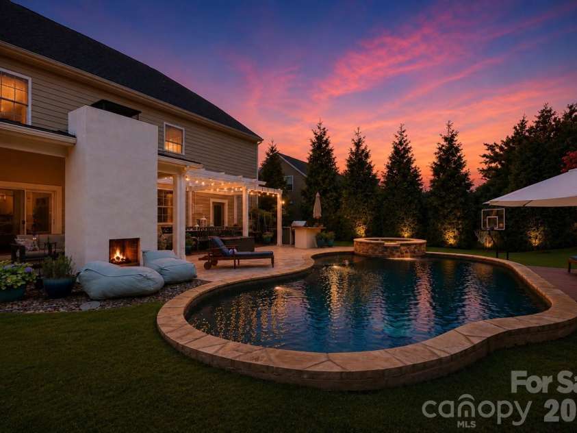 14336 Baytown Court, Huntersville, NC 28078.  MLS# CAR4399744, YatesRealty ID 36107. Resort-style backyard transforms after sunset with dramatic pool and landscape lighting.