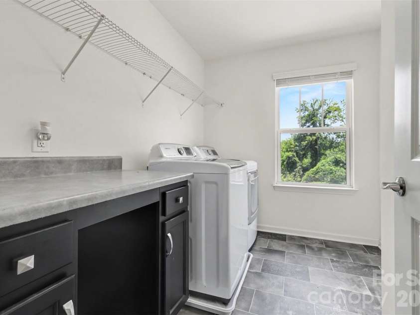 4571 Selhurst Drive, Fort Mill, SC 29707.  MLS# CAR4401865, YatesRealty ID 36119. Laundry room - Folding table