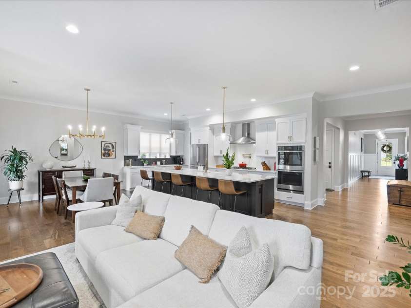 13627 Tranquil Day Drive, Matthews, NC 28105.  MLS# CAR4285895, YatesRealty ID 3613. Living Room, Kitchen, and Dining Space