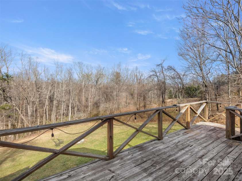 255 & 257 Crescent Street, Saluda, NC 28773.  MLS# CAR4218749, YatesRealty ID 3613. View from 2nd balcony to the backyard. (2022)
