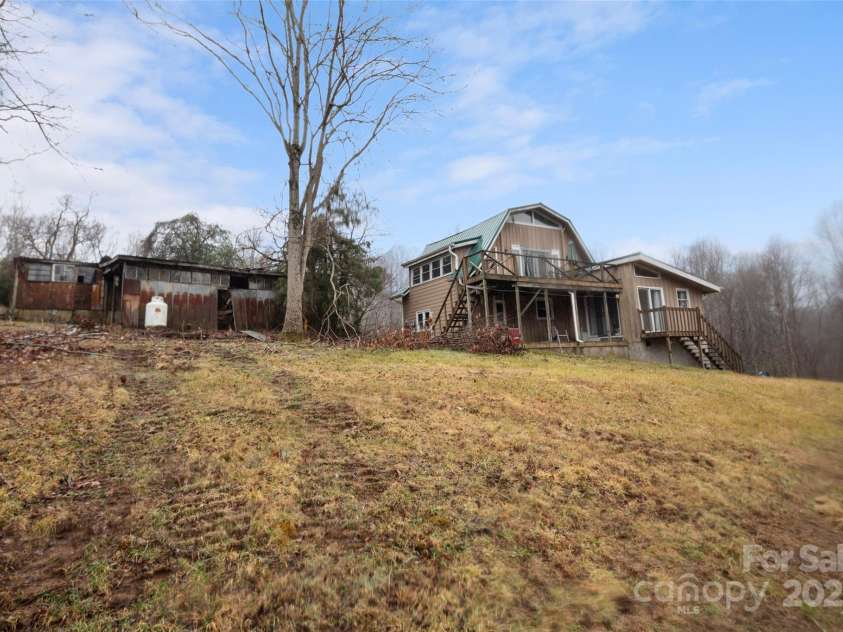 255 & 257 Crescent Street, Saluda, NC 28773.  MLS# CAR4218749, YatesRealty ID 3613. View of Barn House and Animal Run-in behind the three car garage.