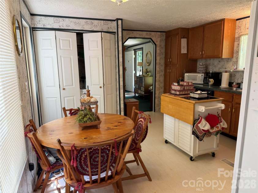 556 Gilbert Road, Columbus, NC 28722.  MLS# CAR4402949, YatesRealty ID 36145. Laundry Closet beside Dining area