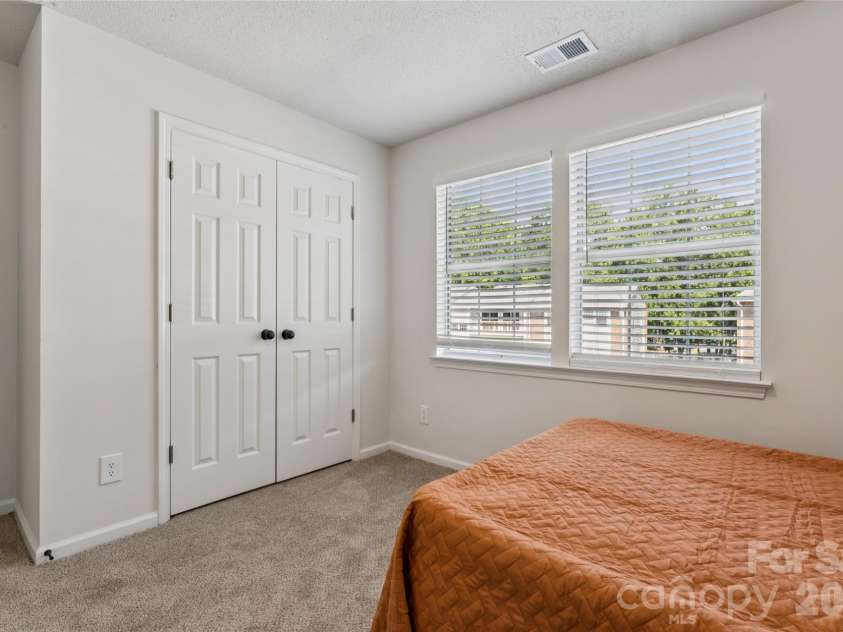 1620 Arlyn Circle, Charlotte, NC 28213.  MLS# CAR4400699, YatesRealty ID 36164. Spacious and inviting third bedroom, recently updated with plush, high-quality carpeting and a fresh coat of neutral paint, complemented by convenient double-door closets providing ample storage space.