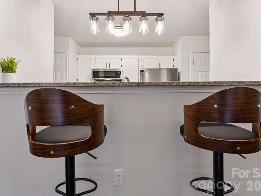 1620 Arlyn Circle, Charlotte, NC 28213.  MLS# CAR4400699, YatesRealty ID 36164. The bar area comfortably accommodates four barstools, providing ample space for entertaining and enjoyment.