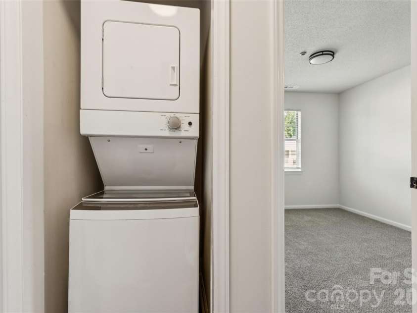 1620 Arlyn Circle, Charlotte, NC 28213.  MLS# CAR4400699, YatesRealty ID 36164. This laundry closet is conveniently situated off the main hallway for easy access, and it comes fully equipped with a high-quality washer and dryer unit.