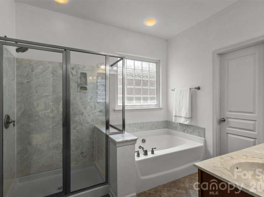 13406 Centennial Commons Parkway, Huntersville, NC 28078.  MLS# CAR4399839, YatesRealty ID 36168. Primary bath with walk in shower, soaking tub and dual sink vanity.