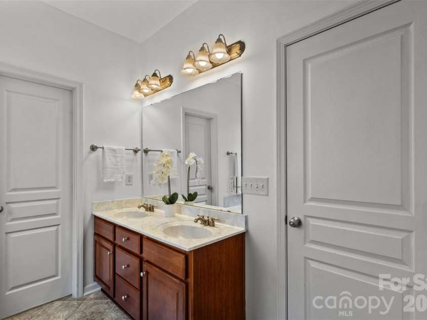13406 Centennial Commons Parkway, Huntersville, NC 28078.  MLS# CAR4399839, YatesRealty ID 36168. The ensuite bath has tile flooring, a huge walk in closet with custom shelving and private water closet.