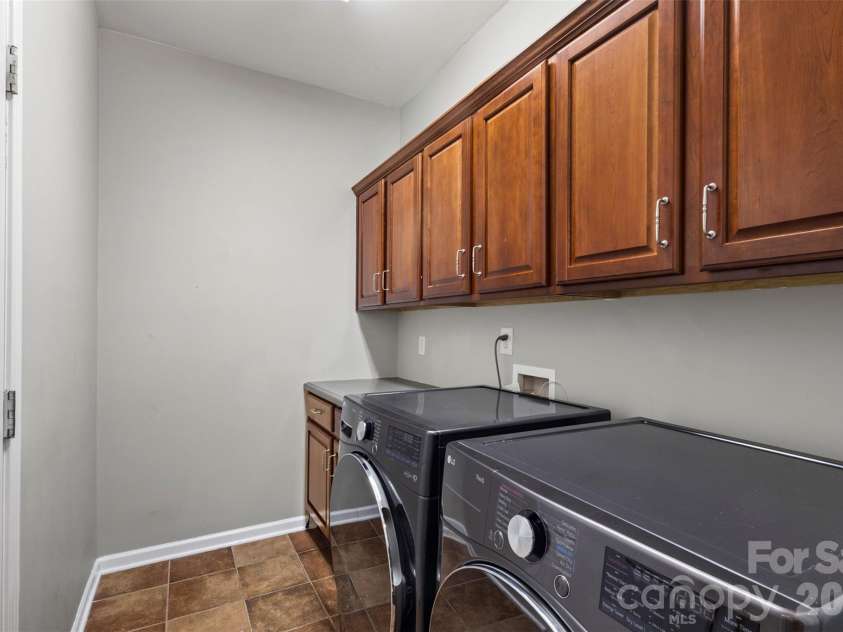 13406 Centennial Commons Parkway, Huntersville, NC 28078.  MLS# CAR4399839, YatesRealty ID 36168. The main level laundry room had cabinets for added storage and tile flooring.