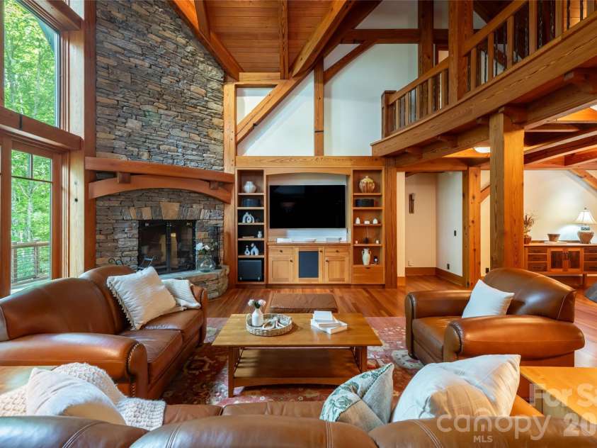 4900 Preserve Road, Sylva, NC 28779.  MLS# CAR4393548, YatesRealty ID 36172. Floor to ceiling fireplace and reclaimed timbers from a 100 year old tractor factor create something truly unique and irreplaceable