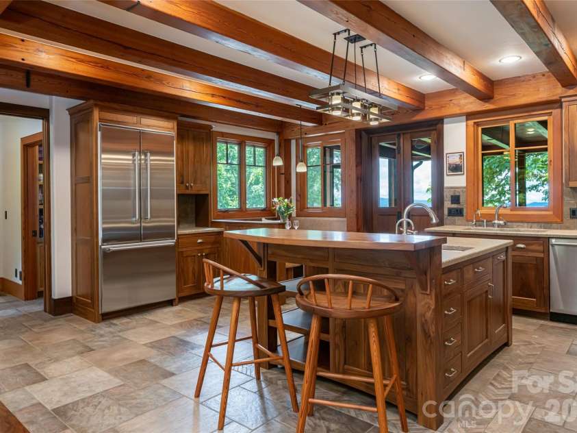 4900 Preserve Road, Sylva, NC 28779.  MLS# CAR4393548, YatesRealty ID 36172. The spacious kitchen offers both a large dining area and breakfast buffet with a view