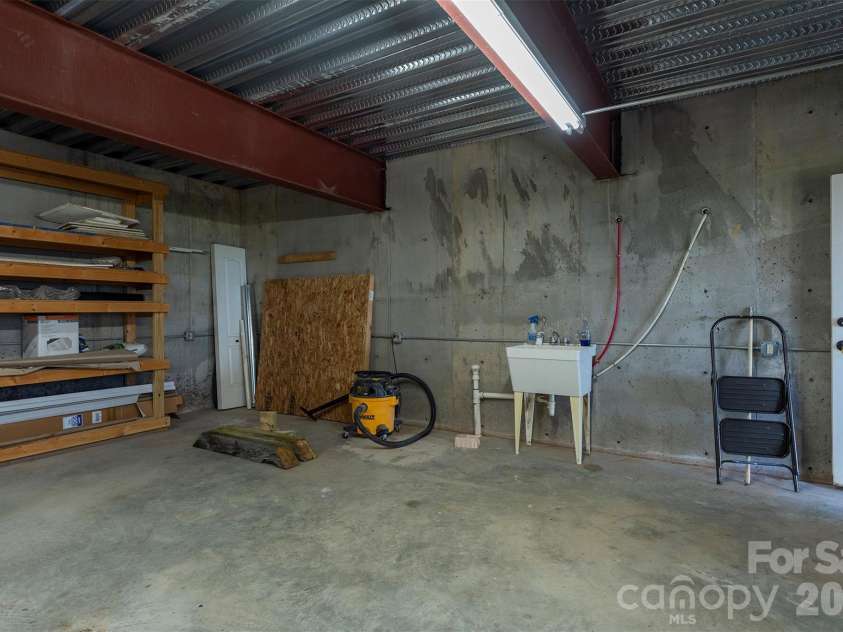 301 Oak Winds Drive, Old Fort, NC 28762.  MLS# CAR4399378, YatesRealty ID 36175. Huge workshop under garage