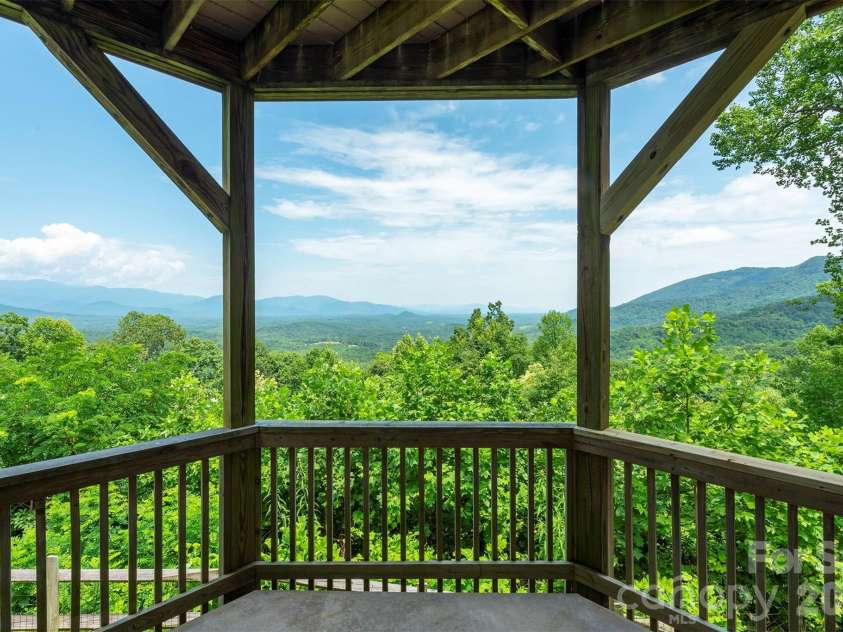 301 Oak Winds Drive, Old Fort, NC 28762.  MLS# CAR4399378, YatesRealty ID 36175. Lower level covered wrap around deck