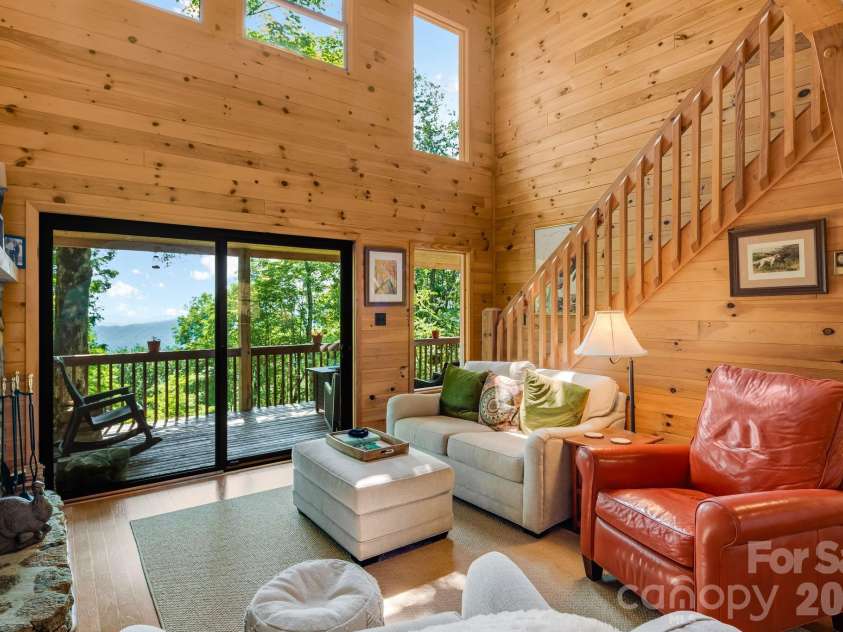 46 Trillium Lane, Mars Hill, NC 28754.  MLS# CAR4399565, YatesRealty ID 36188. Living room flows onto the outdoor living room overlooking the mountains.