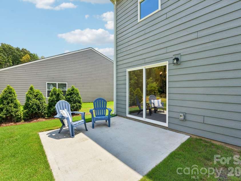 148 Tanner Loop, Troutman, NC 28166.  MLS# CAR4401637, YatesRealty ID 36232. Back patio with afternoon shade