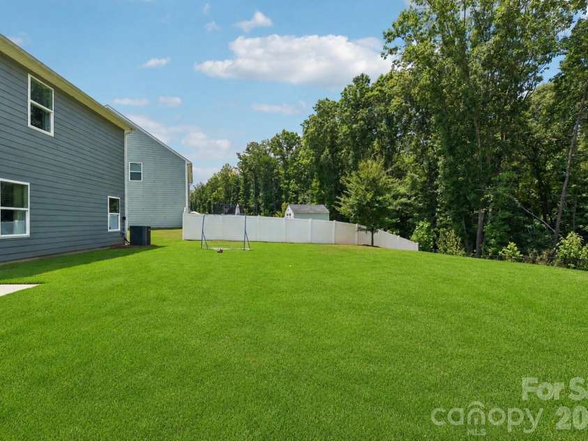 148 Tanner Loop, Troutman, NC 28166.  MLS# CAR4401637, YatesRealty ID 36232. Level backyard